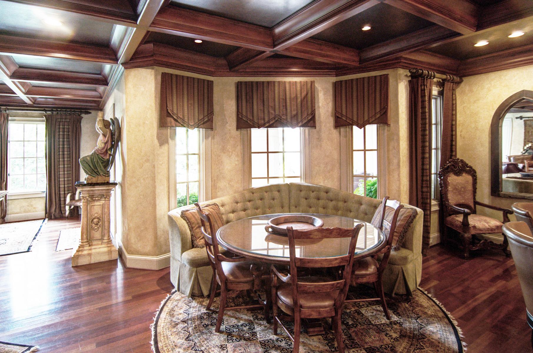 Wood grained coffer ceiling with  faux metal inserts and Tuscan colored plaster walls. Beautiful!