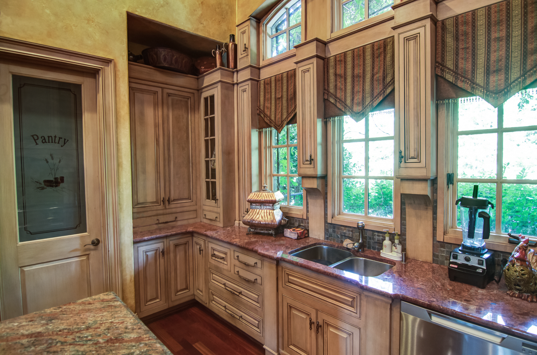 European colored plaster walls with matching cabinet glaze on wall panels.