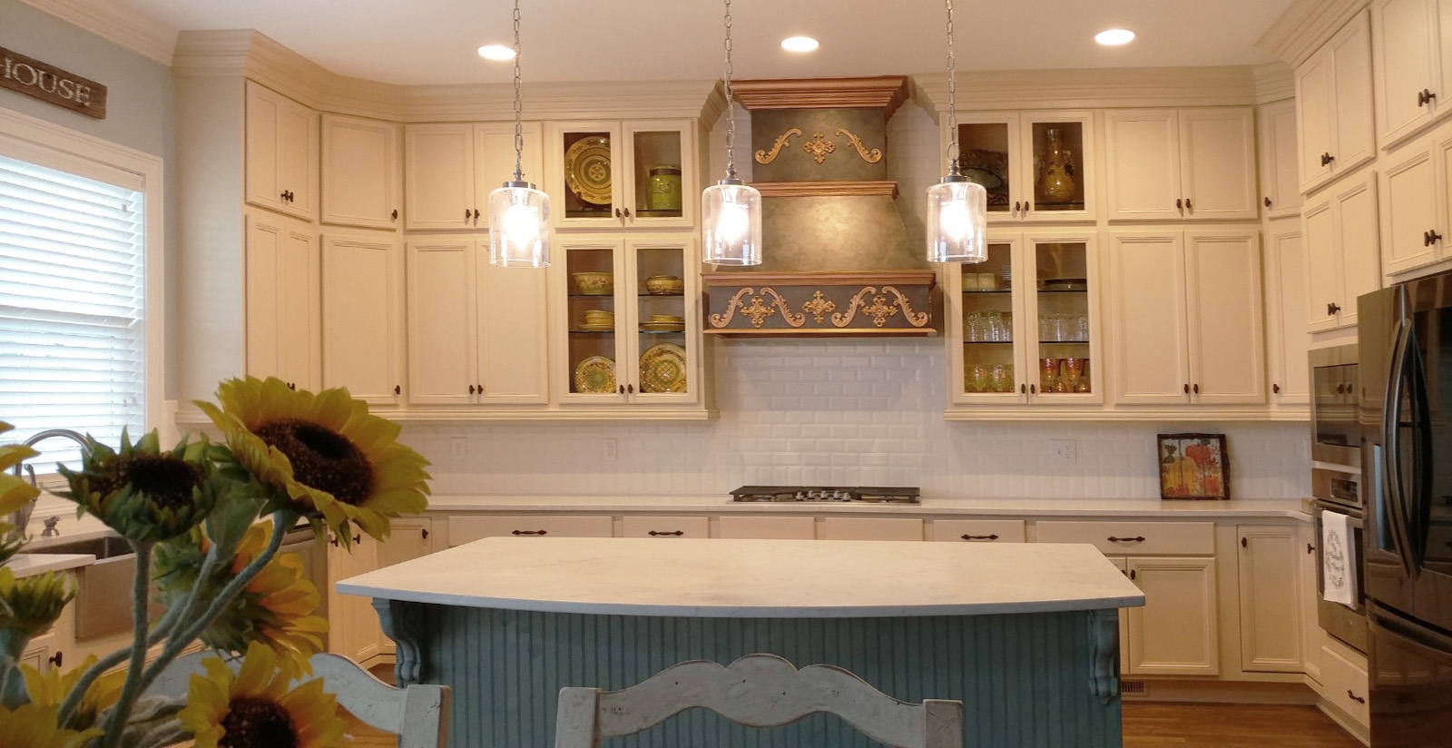 French Country Kitchen design with faux bronze and copper hood