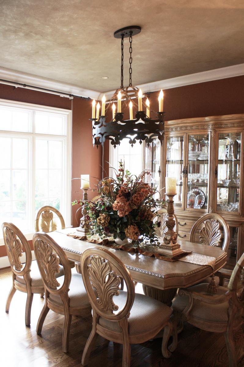 Beautiful wall color and shimmering accented ceiling complete this dining rooms design.