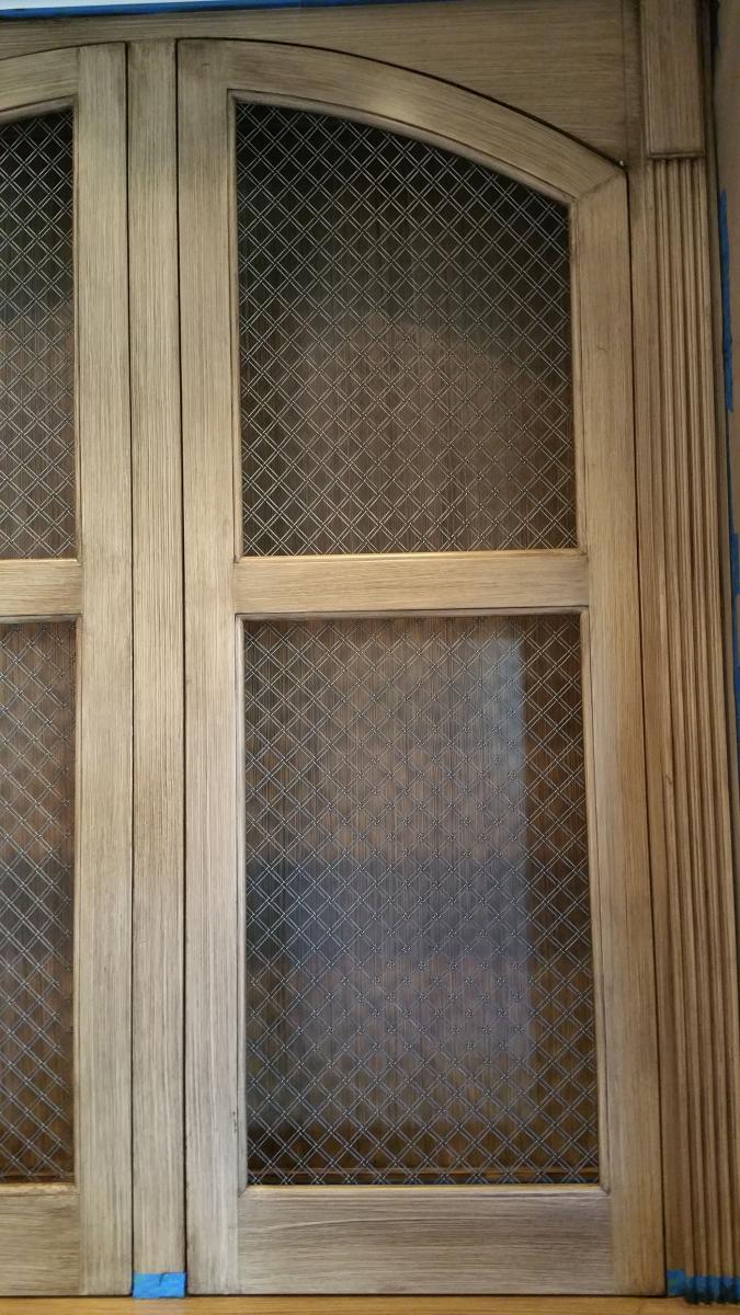 Wood grained built-in cabinets and painted feature wall and glazed hearth.