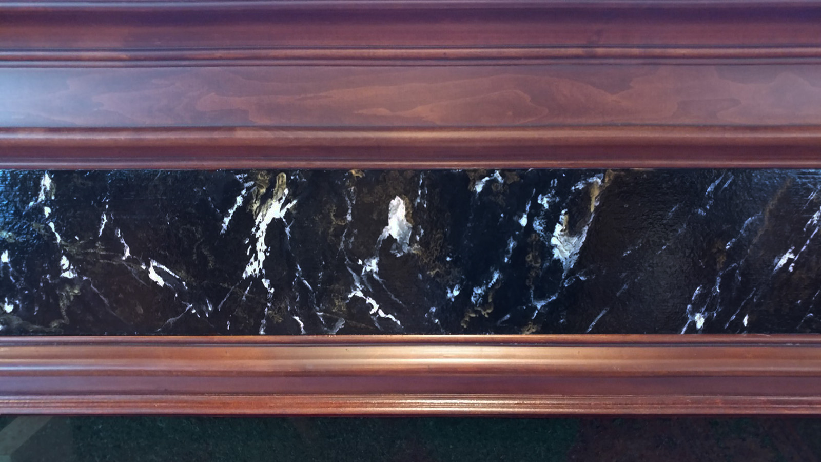 wood-grain mantel and faux marble insert.