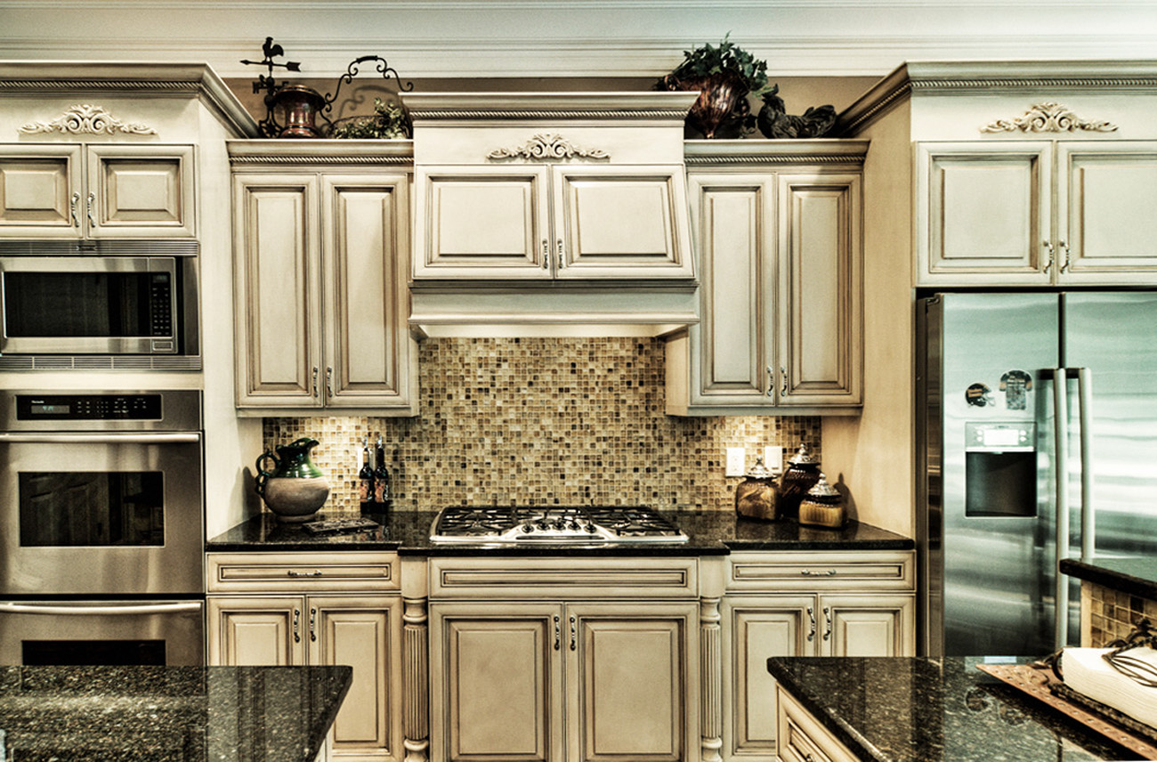 Before and After – These kitchen cabinets and breakfast bar were given a new life with modern color mixture and furniture glazing technique in Franklin, TN.