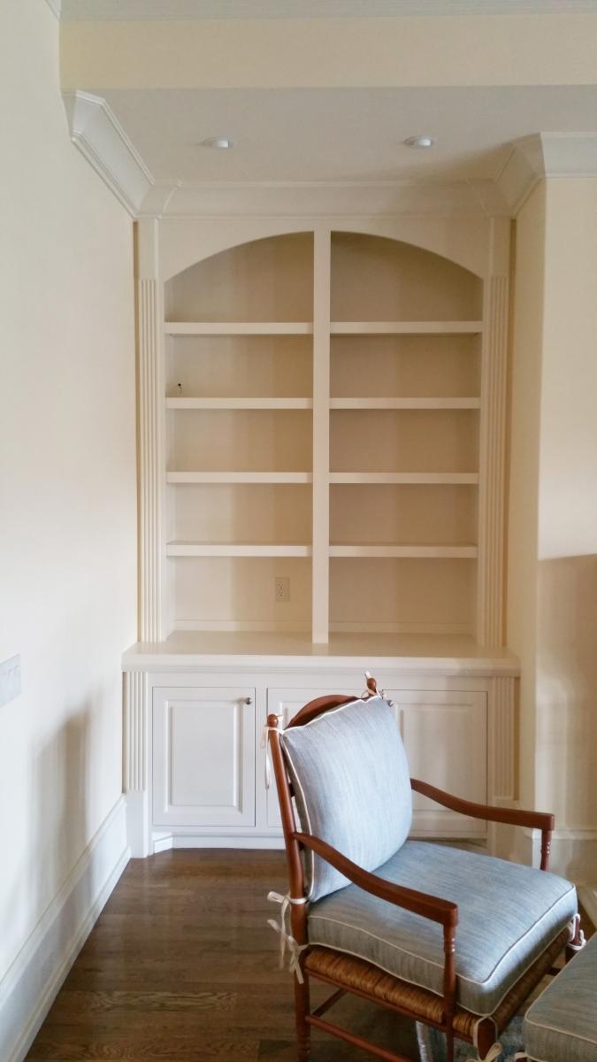 Before- Wood grained built-in cabinets and painted feature wall and glazed hearth.