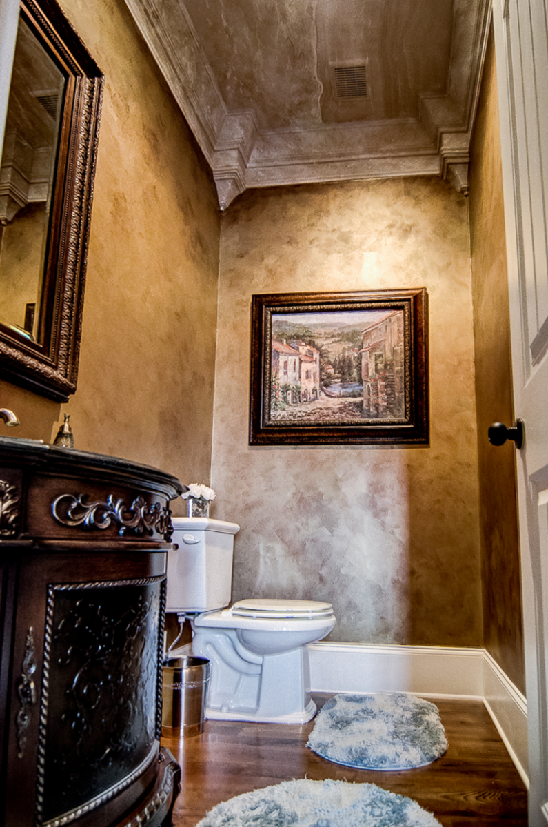 Metallic wall finish and faux limestone ceiling.