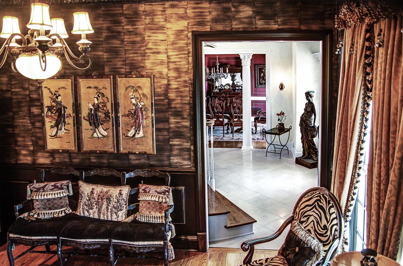 Black woodwork with gold faux bamboo walls and faux metal plaster cornice above.