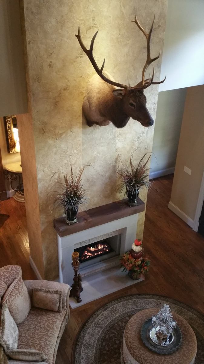 Custom great room wall color with a rustic faux plaster feature wall.