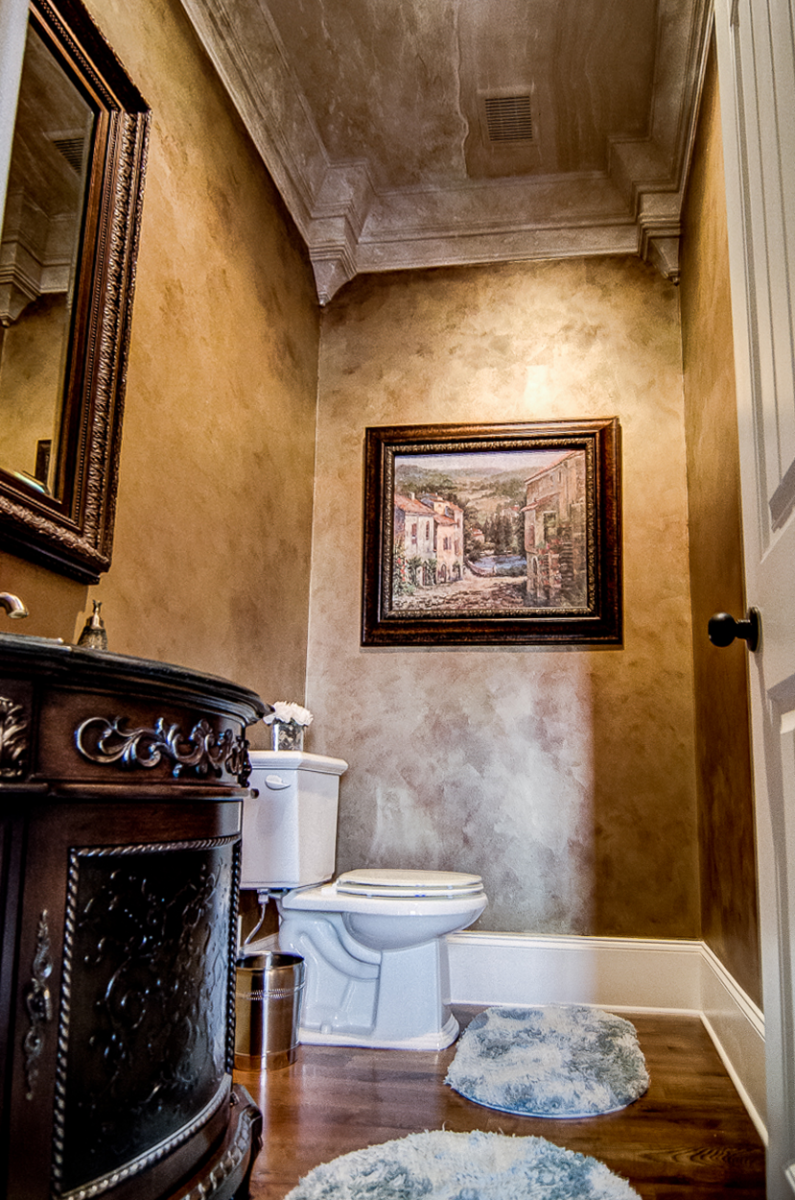Powder room makeover - Bronze and gold metallic walls with a faux travertine ceiling cap.
