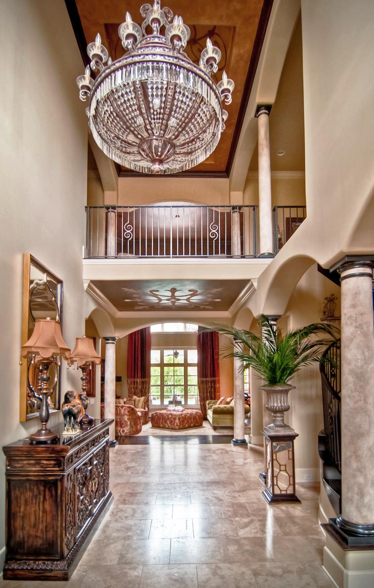 Faux stone plaster columns, metallic bronze capitals and base caps the right wall color paired with a 3D scroll relief ceiling mural. Just Beautiful!