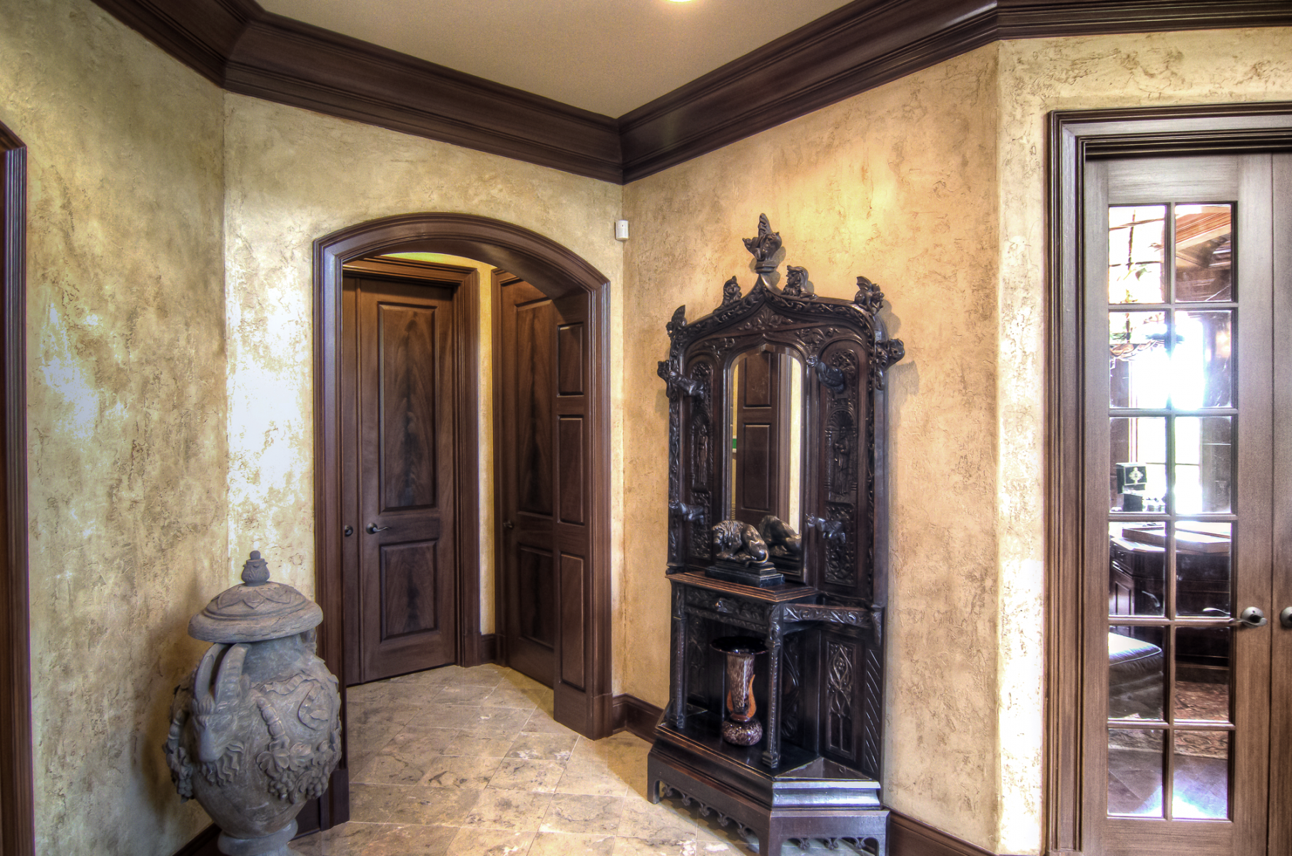 European plaster walls with wood glazed trim and faux mahogany master bedroom entrance doors.