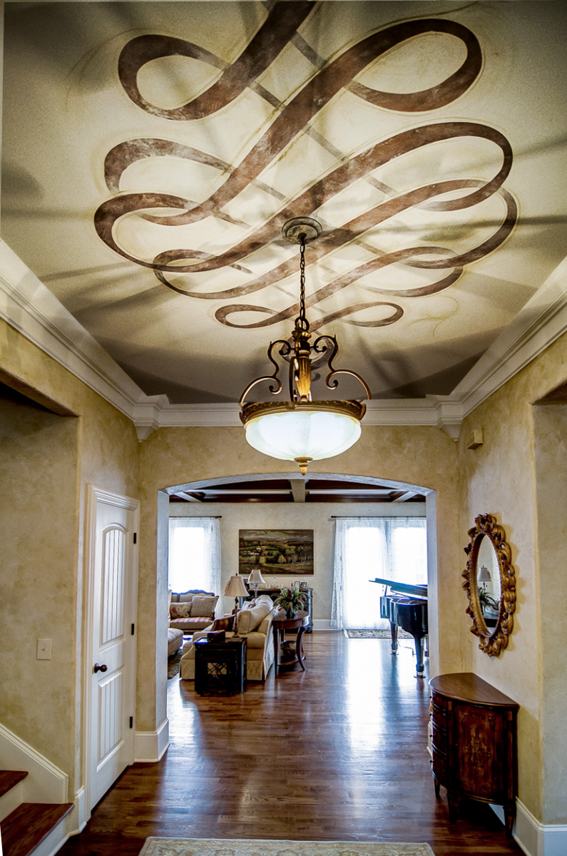 European plaster walls with a hand painted metallic Modello ceiling scroll fresco.