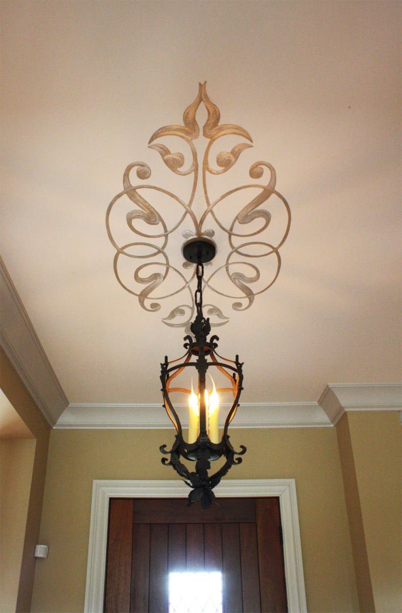 Hand painted ceiling design with gold and silver flourishes.