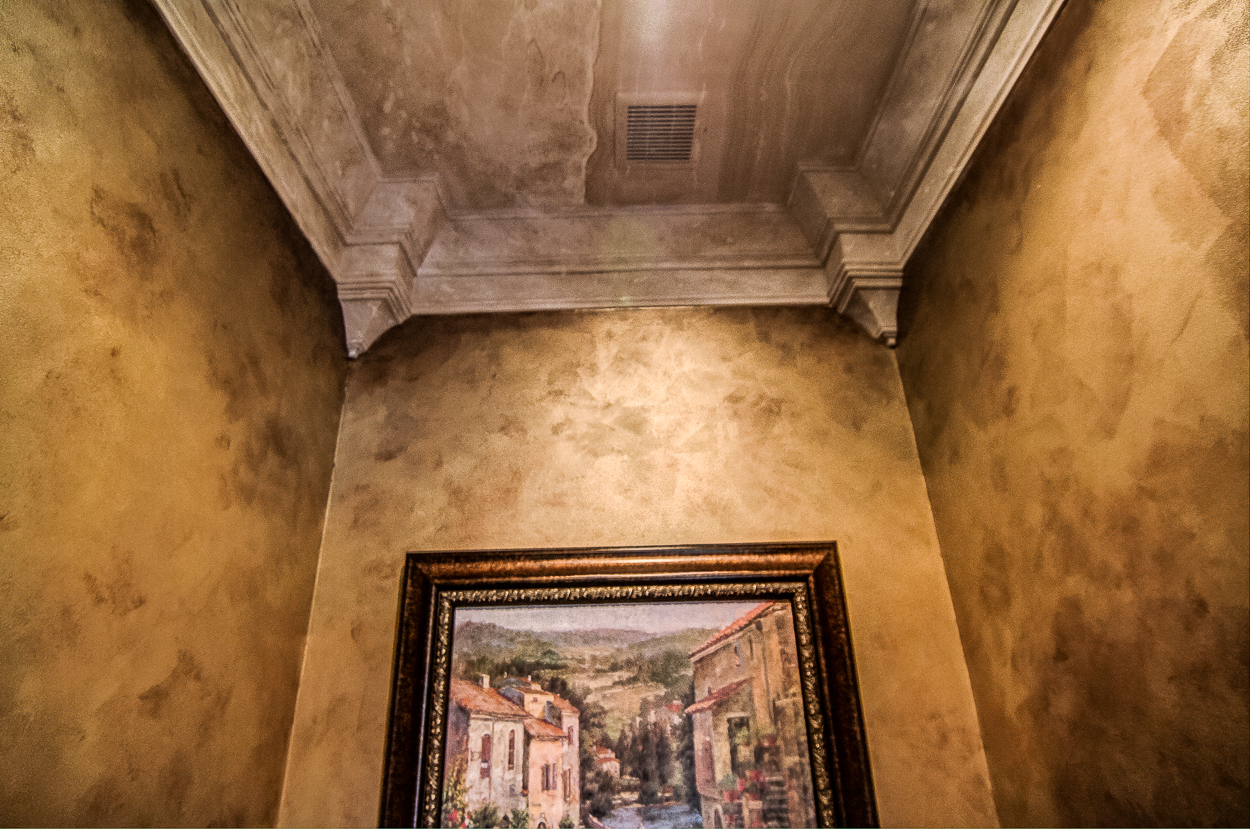 Powder room makeover - Bronze and gold metallic walls with a faux Travertine ceiling cap close-up.