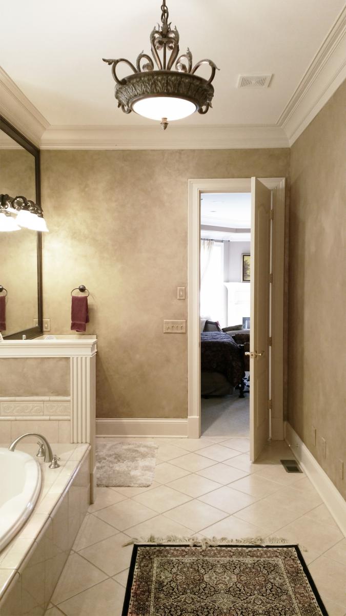 Master Bath Shimmering Lusterstone walls with custom faux designed mirror frames.