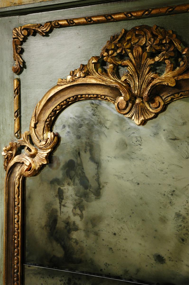 Faux antiquing on mirror glass with gold leafing on mirror frame trim.