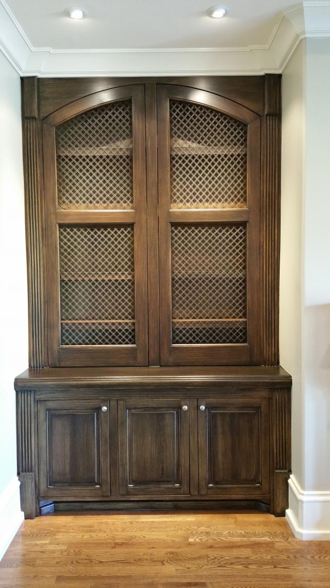 Wood grained built-in cabinets and painted feature wall and glazed hearth.