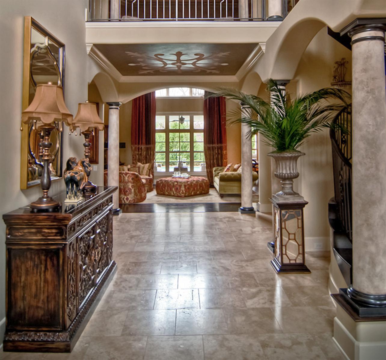 Classic design of custom ceiling mural and Spanish custom plaster glazed columns with bronze caps and bases.