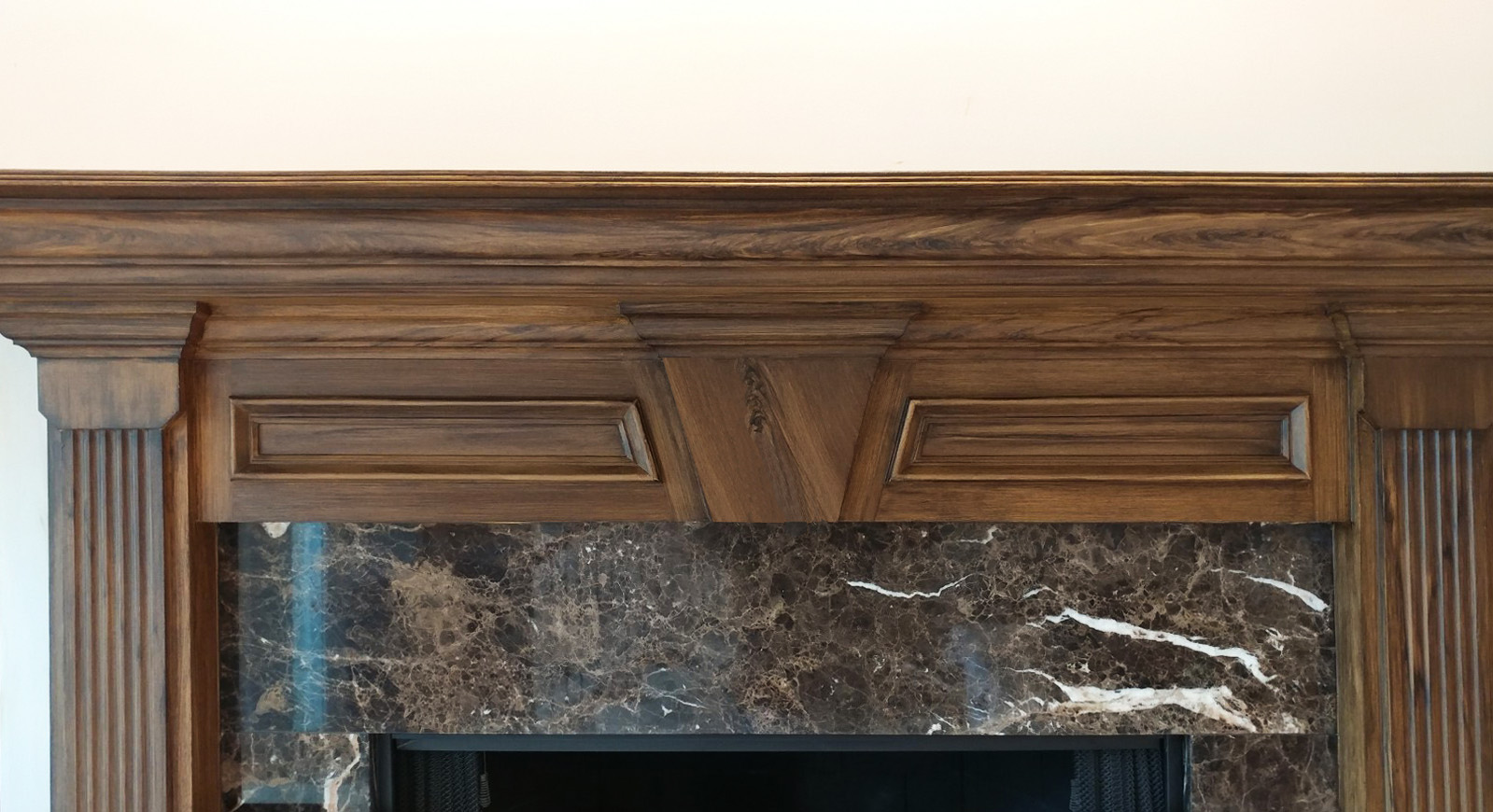 faux walnut wood grain on fireplace mantel