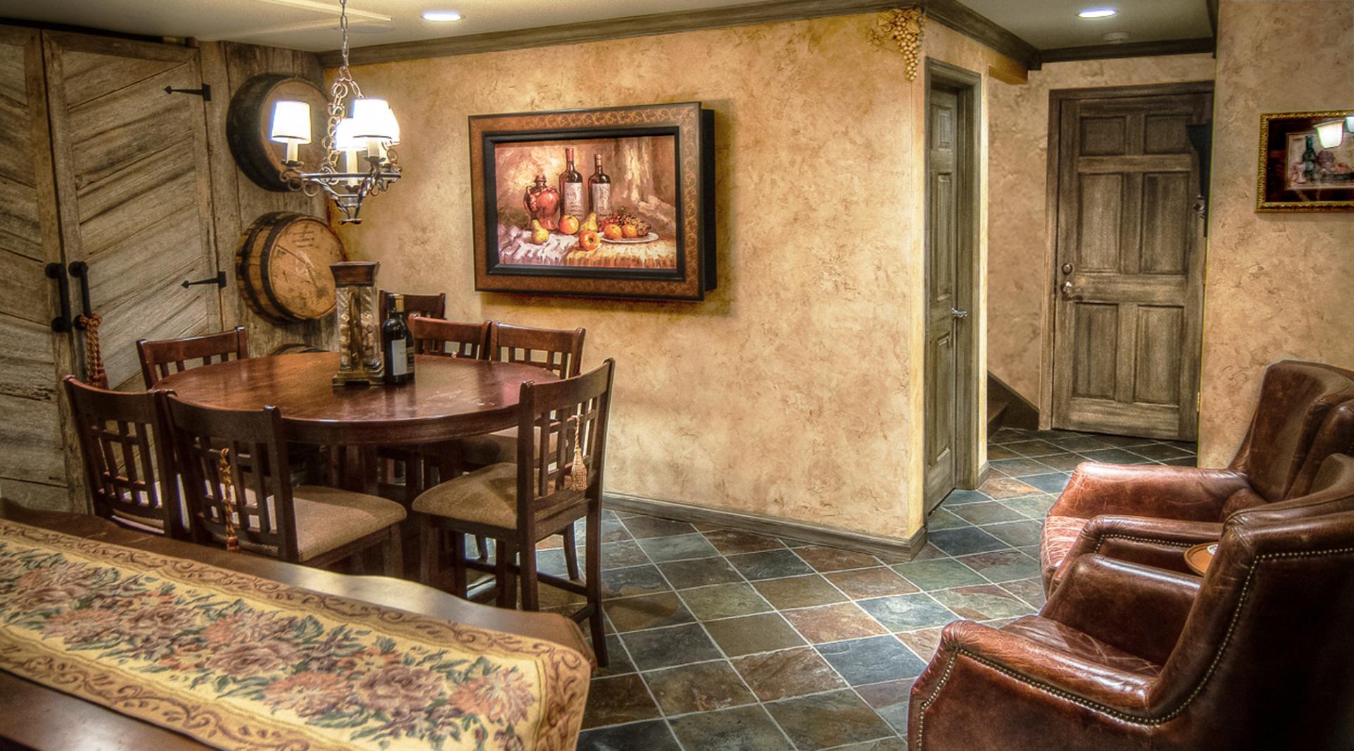 Wine Tasting Room Makeover - Tuscan plaster walls, chiseled grape motifs and faux finished barn siding trim and doors.