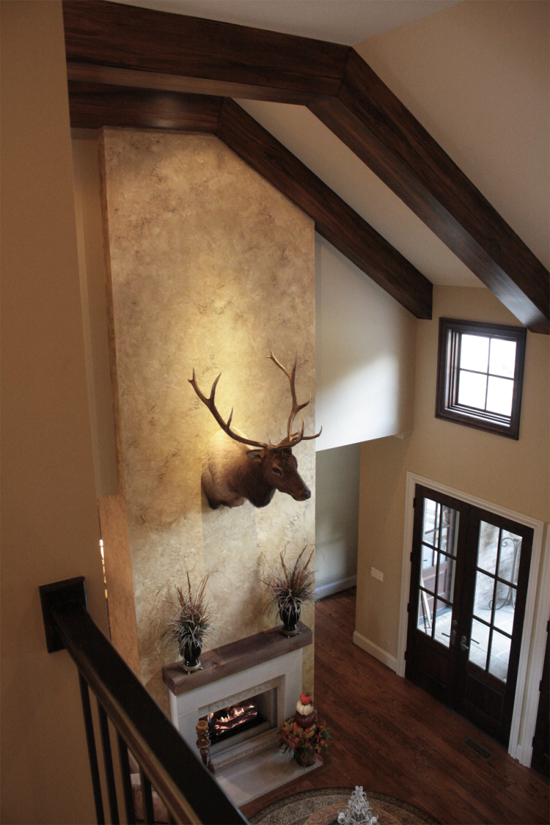 Beautiful wall color and feature wall plaster faux design and faux wood ceiling beams.