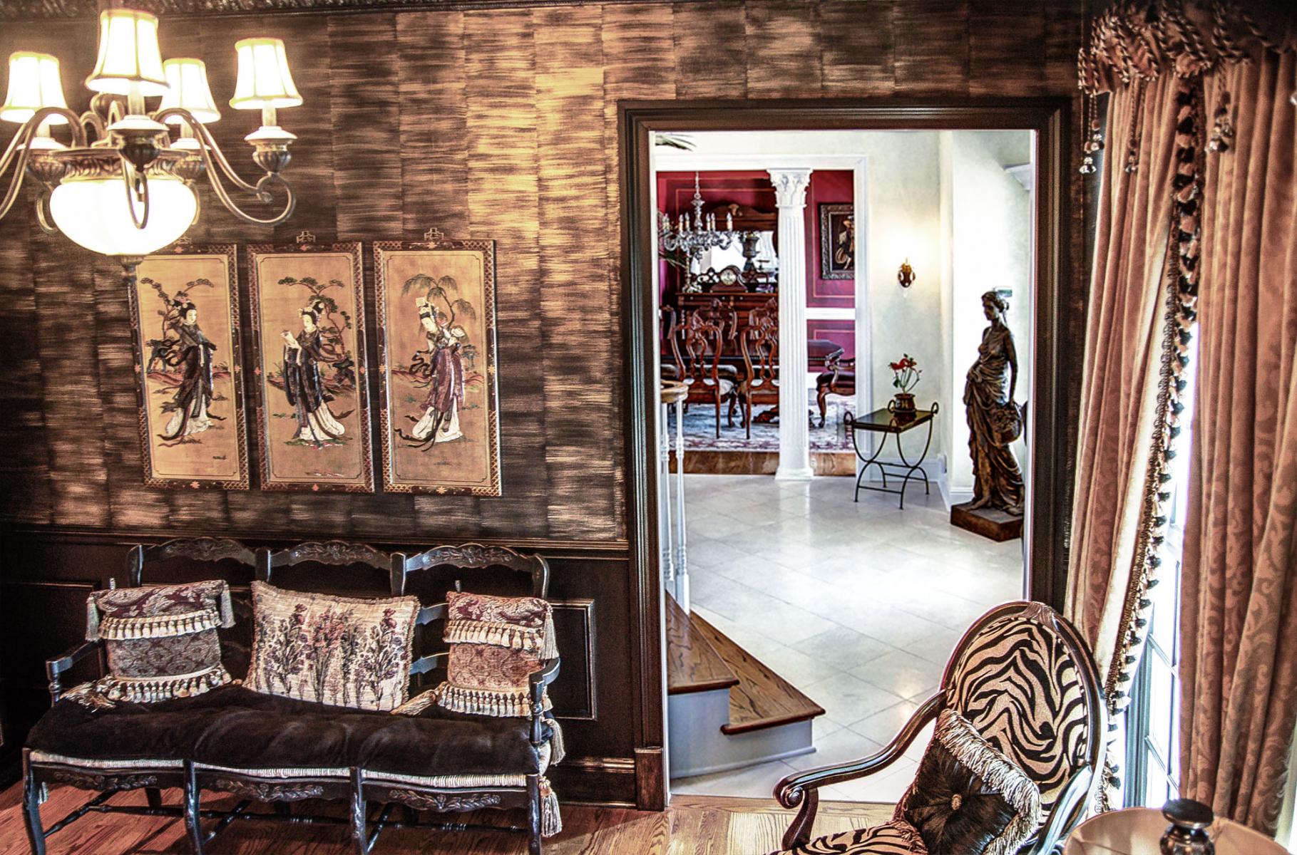 Black woodwork with gold faux bamboo walls and faux metal plaster cornice above.