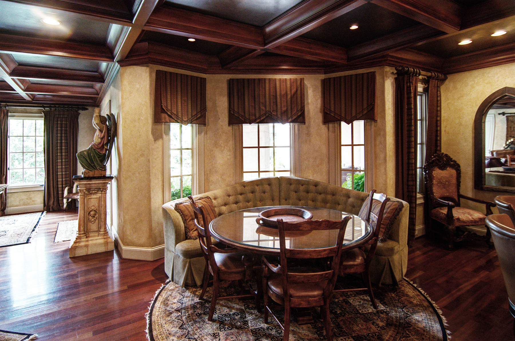 Wood grained coffer ceiling with  faux metal inserts and Tuscan colored plaster walls. Beautiful!